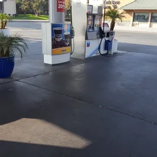 a person sitting on a bench at a gas station