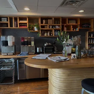 a kitchen with a counter and chairs