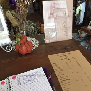 a table with a menu and a notepad