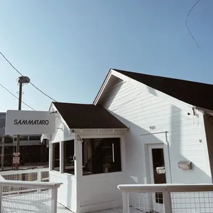 a white building with a black roof
