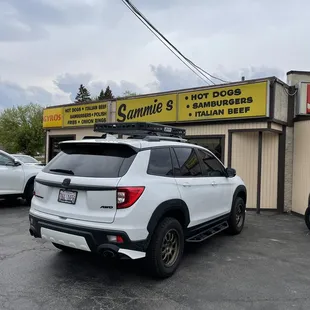 a white suv parked in front of a store