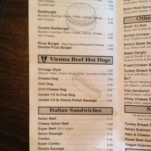 a person holding a menu in their hand