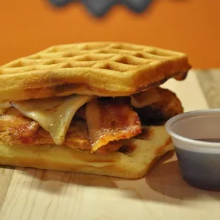 a waffle sandwich with bacon and cheese