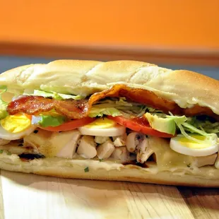 a chicken sandwich on a cutting board