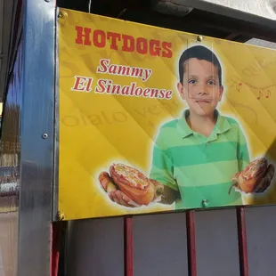 a boy holding a hotdog