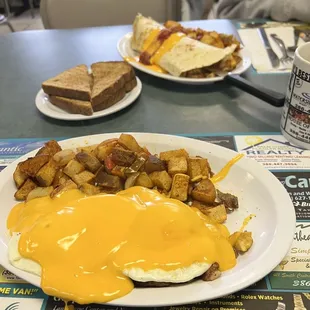 Cheese eggs over corn beef hash and ham burrito with home fries!!