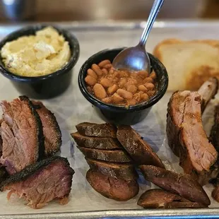 Three meat plate (ribs, brisket and sausage) with potato salad and pinto beans.
