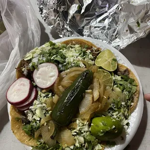 Fully loaded with yellow tortillas. Carnitas , asada, and cabeza