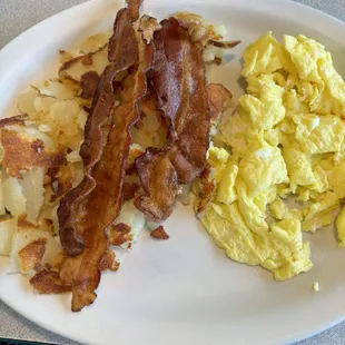 Scrambled eggs, hash browns, bacon