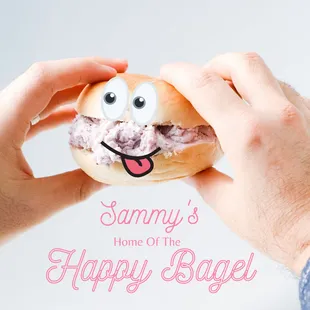 someone holding a bagel with a happy face