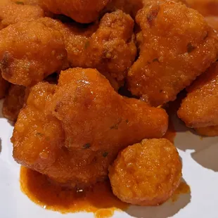 Deep fried cauliflower with the buffalo sauce fried in... This is the way that veggie wings should be!