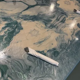 Table w/ badges epoxy-embedded into the surface in honor to the local PD who backed this restaurant in tough times.