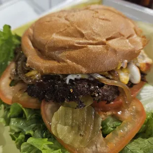 a hamburger with lettuce and tomato