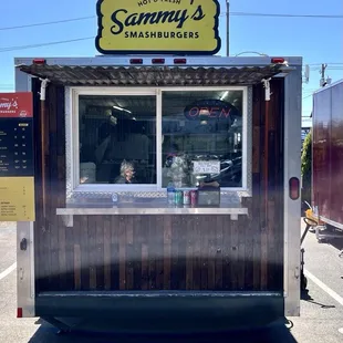 A small cart with big burgers