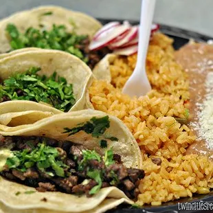 A plate of 3 tacos with side of Rice, beans $4.99
