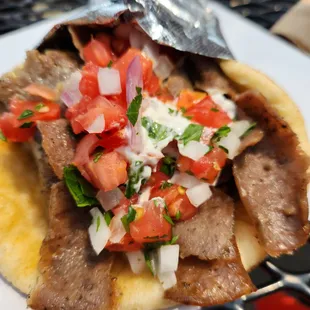 a pita with meat and tomatoes