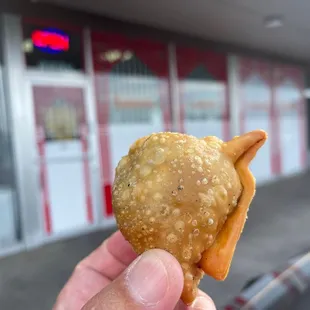 a hand holding a snack