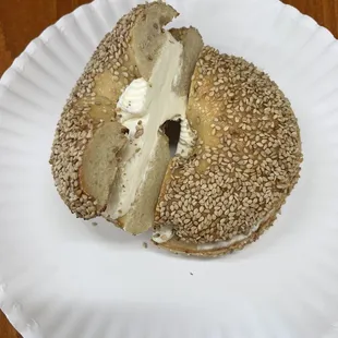 Sesame bagel with plain cream cheese - seeds on top and bottom