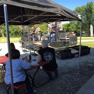a band playing under a tent