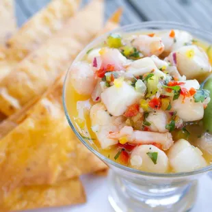 a glass of shrimp salad with tortillas