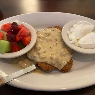 Country Fried Steak and Poached Eggs with a side of fresh fruit