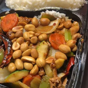 a tray of stir fried vegetables and cashews