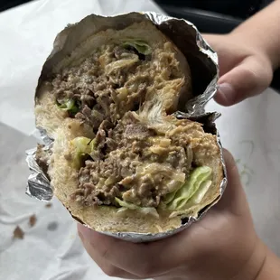 My son opened his cheesesteak this way, yellow American, fried onions, lettuce.