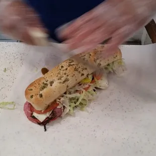 A footlong Double Meat Pepperoni, Salami, and Pastrami on Jalapeno bread. Sam showing off his blazing fast knife skills.
