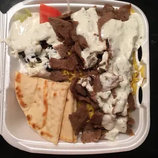 Gyro plate to go! TONS of meat, tons of rice, great side salad and pita with cucumber sauce! This could easily be shared by 2. MmmmMmmmGood!