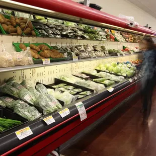 a woman walking past a produce section