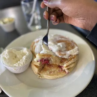 Old Glory Pancakes filled with Raspberries, White Chocolate Chips and a side of Vanilla Whipped Cream