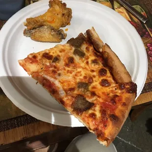 Over cooked pizza and wings. This was supposed to be one slice? Who cut this?