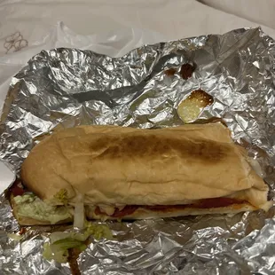 a sandwich wrapped in foil