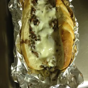 a hot dog covered in cheese