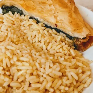 a plate of food with rice and spinach