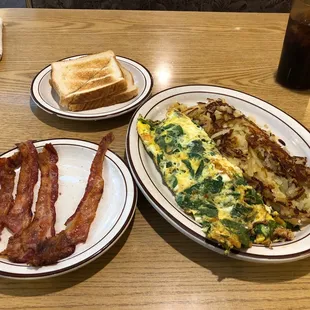 Spinach feta omelette with side of bacon cooked perfect of excellent quality