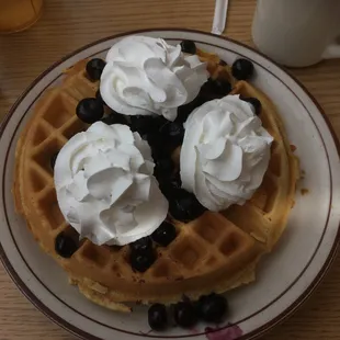 Belgian waffle with whip cream and blueberries
