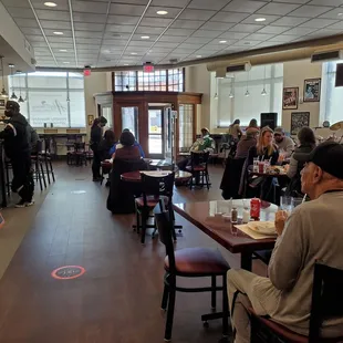 people sitting at tables in a restaurant