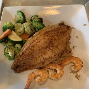 Redfish with mixed veggies, dirty rice and grilled shrimp.