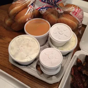 Mile's sauce (it's good), house BBQ sauce, slaw (very good), and twice baked potato salad (very very rich but good)