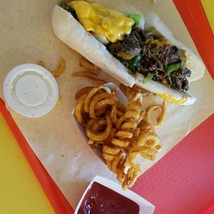 Philly Cheese Steak sandwich w/ a side of curly fries! AMAZING!!! :)