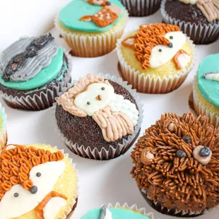 a box of cupcakes decorated with animals