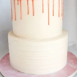 a white cake with pink icing