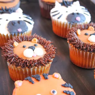 a tray of cupcakes decorated like animals