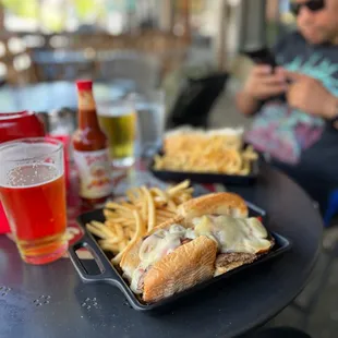 a tray of cheeseburgers and fries