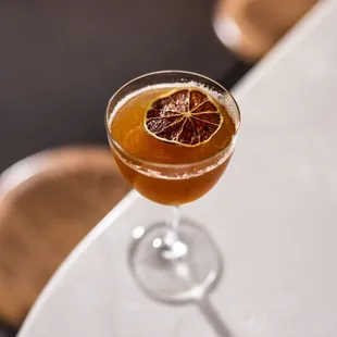 a glass of orange juice on a table