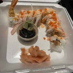 a tray of sushi and shrimp