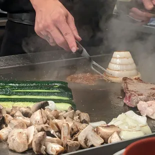 Vegetables and meat cooking with onion volcano about to erupt