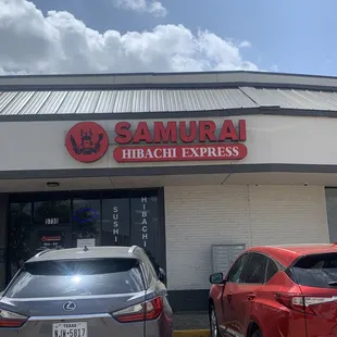 two cars parked in front of a building