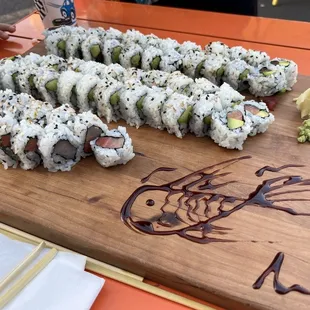 Fish drawing our sushi board of tuna avocado, salmon avocado, and yellowtail rolls